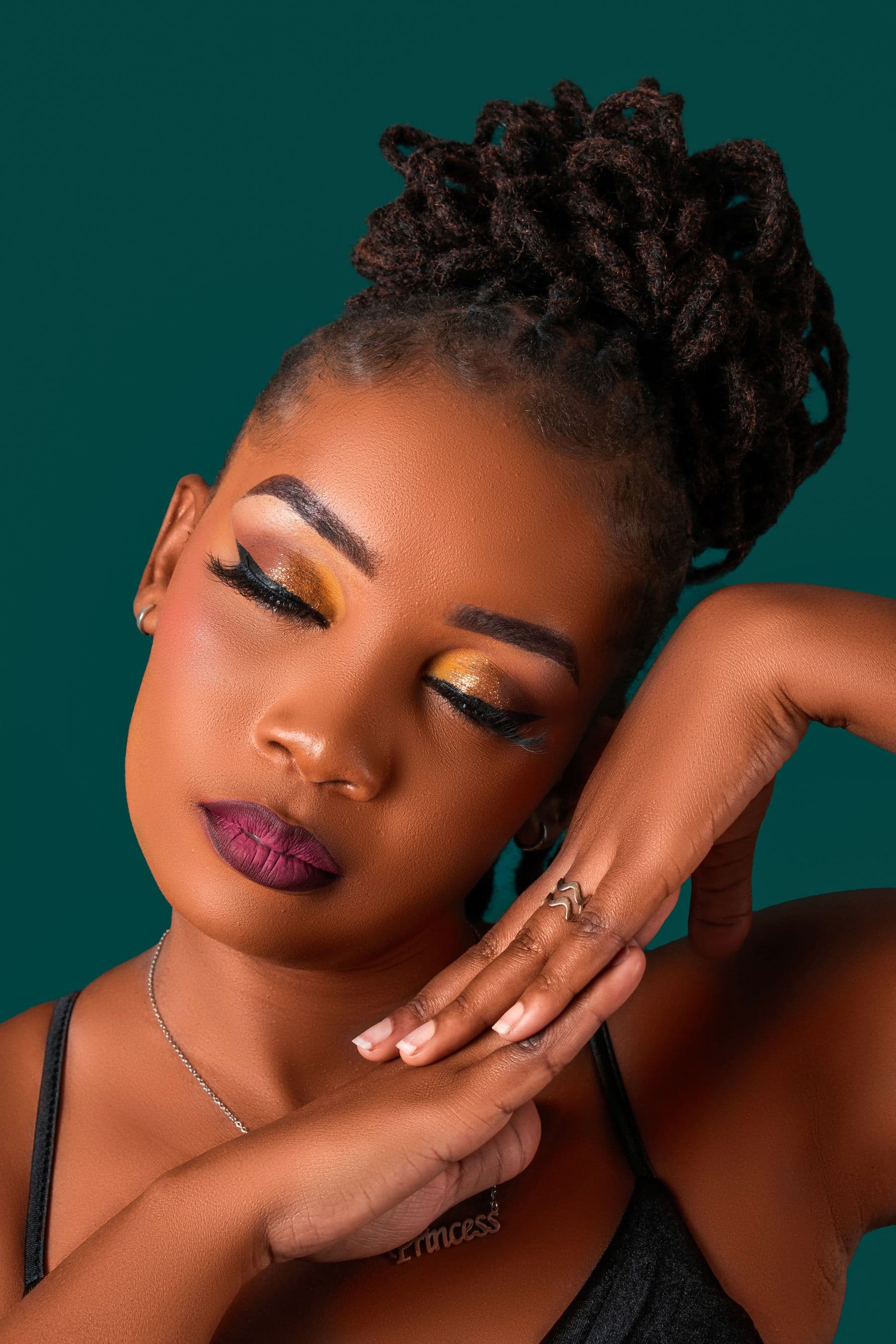 Locs gathered into a polished high updo